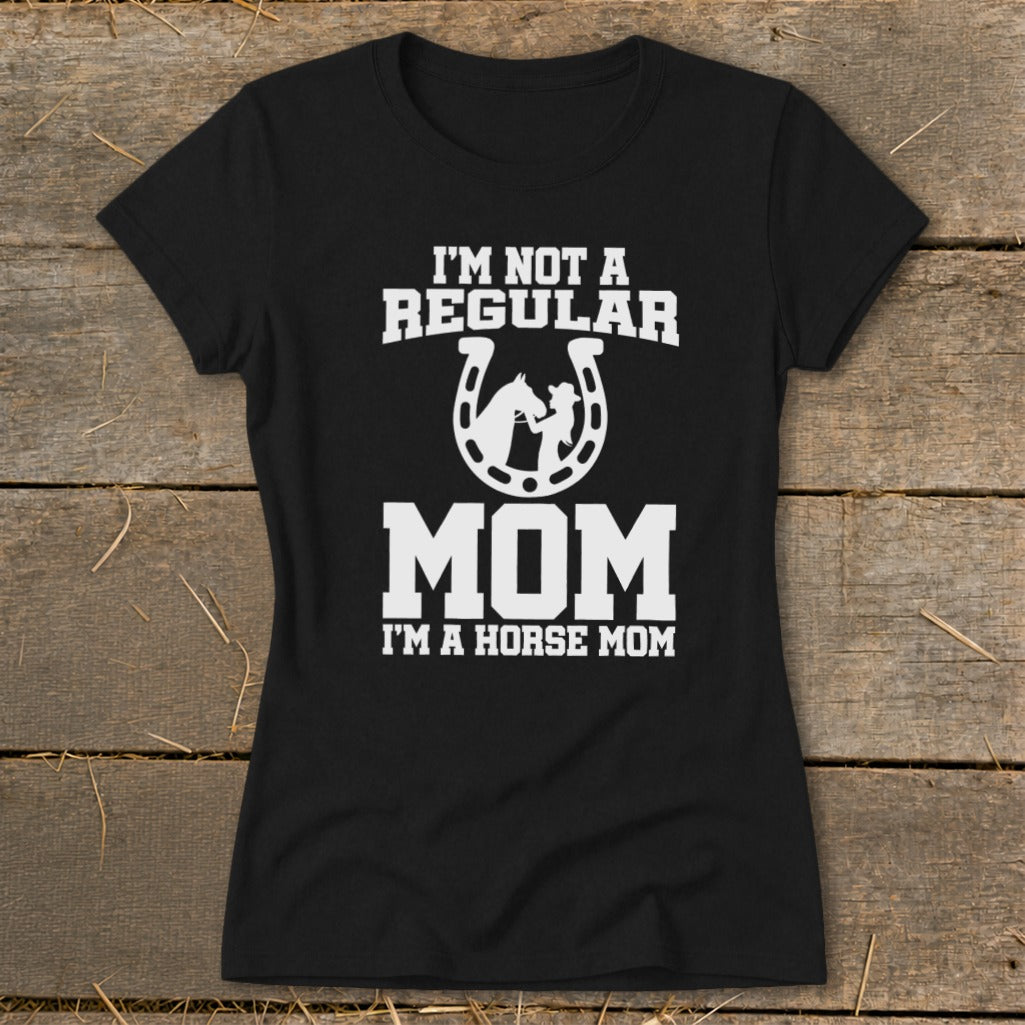 Black t-shirt with white text "I'm Not A Regular Mom I'm A Horse Mom" and horseshoe graphic.