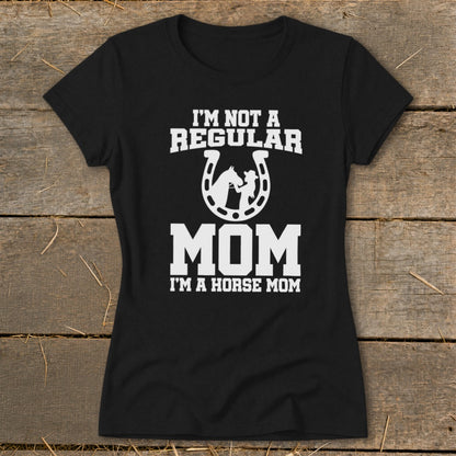 Black t-shirt with white text "I'm Not A Regular Mom I'm A Horse Mom" and horseshoe graphic.