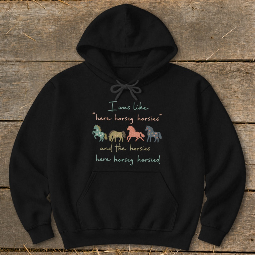 Black hoodie with text "I was like 'here horsey horsies' and the horsies here horsey horsied" and four patterned horses.