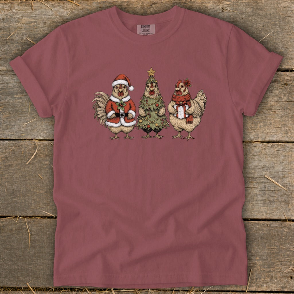 Rooster in Santa suit, chicken dressed as Christmas tree, and chicken with gift.