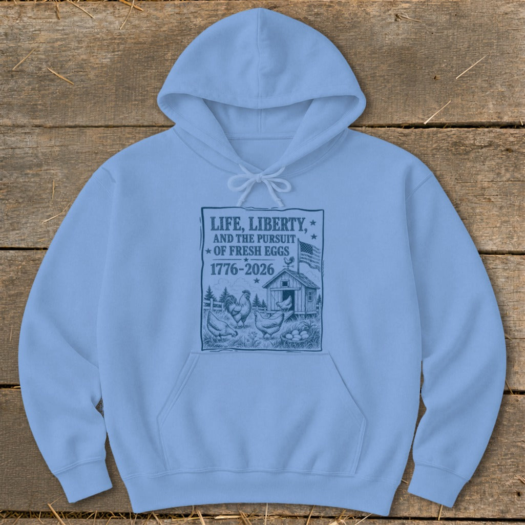 Light blue hoodie with text "Life, Liberty, and the Pursuit of Fresh Eggs 1776-2026".