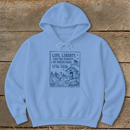 Light blue hoodie with text "Life, Liberty, and the Pursuit of Fresh Eggs 1776-2026".