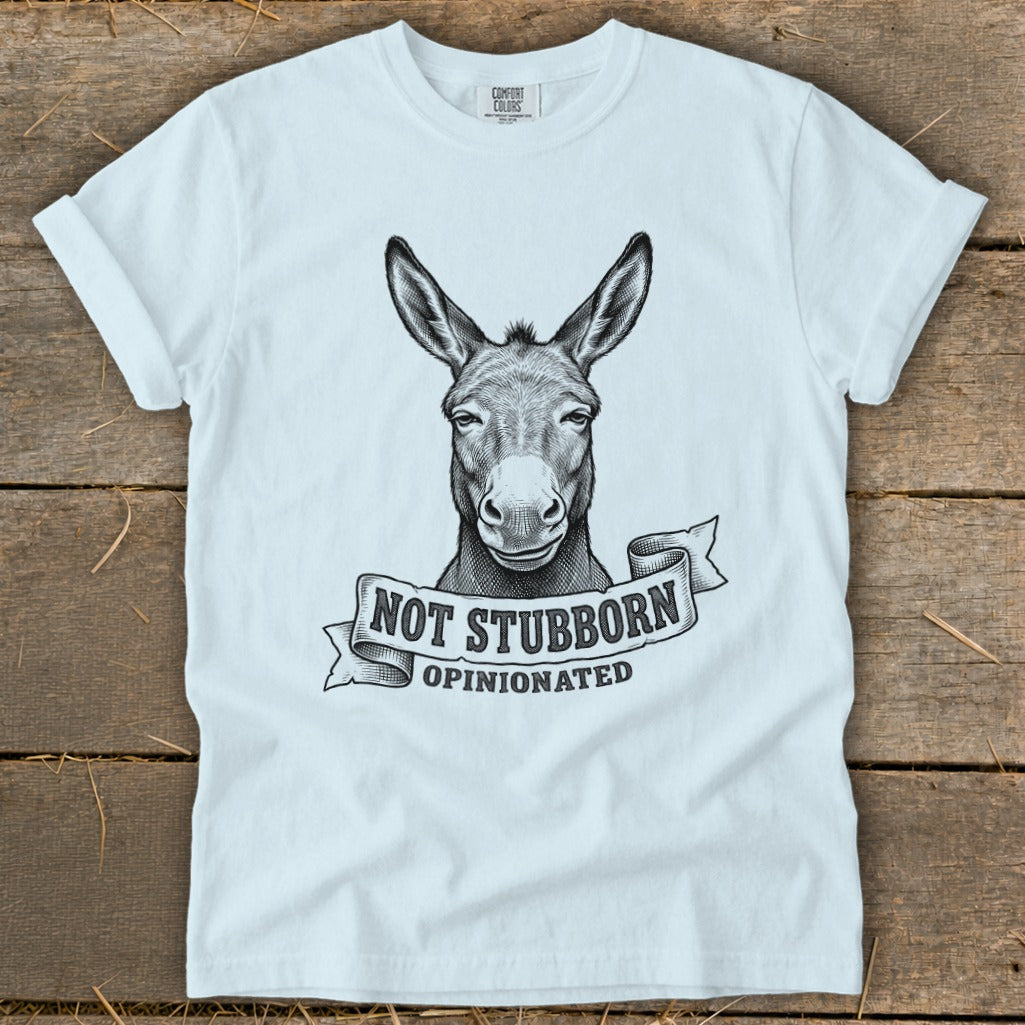 White t-shirt with a black ink drawing of a donkey's head and the text "NOT STUBBORN OPINIONATED".