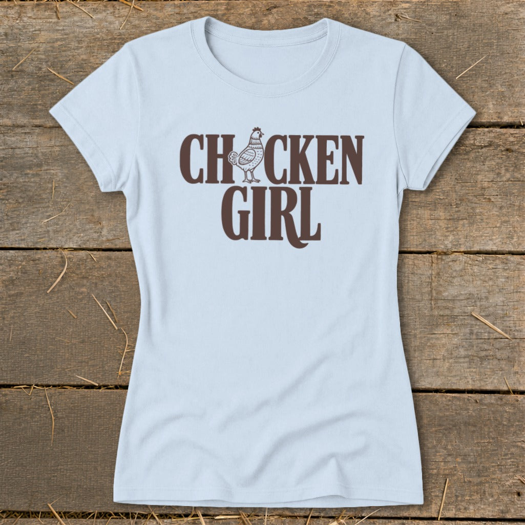 Light blue t-shirt with brown text and chicken graphic reading "CHICKEN GIRL".