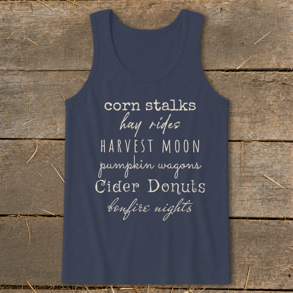 Navy tank top with text listing fall activities: corn stalks, hay rides, harvest moon, pumpkin wagons, cider donuts, bonfire nights.