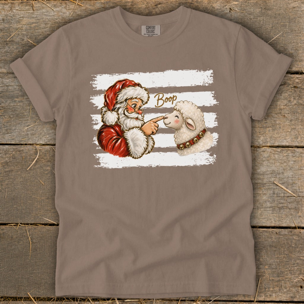 Santa booping a sheep with the word "Boop" on a Comfort Colors t-shirt.