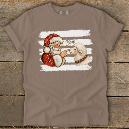 Santa booping a sheep with the word "Boop" on a Comfort Colors t-shirt.