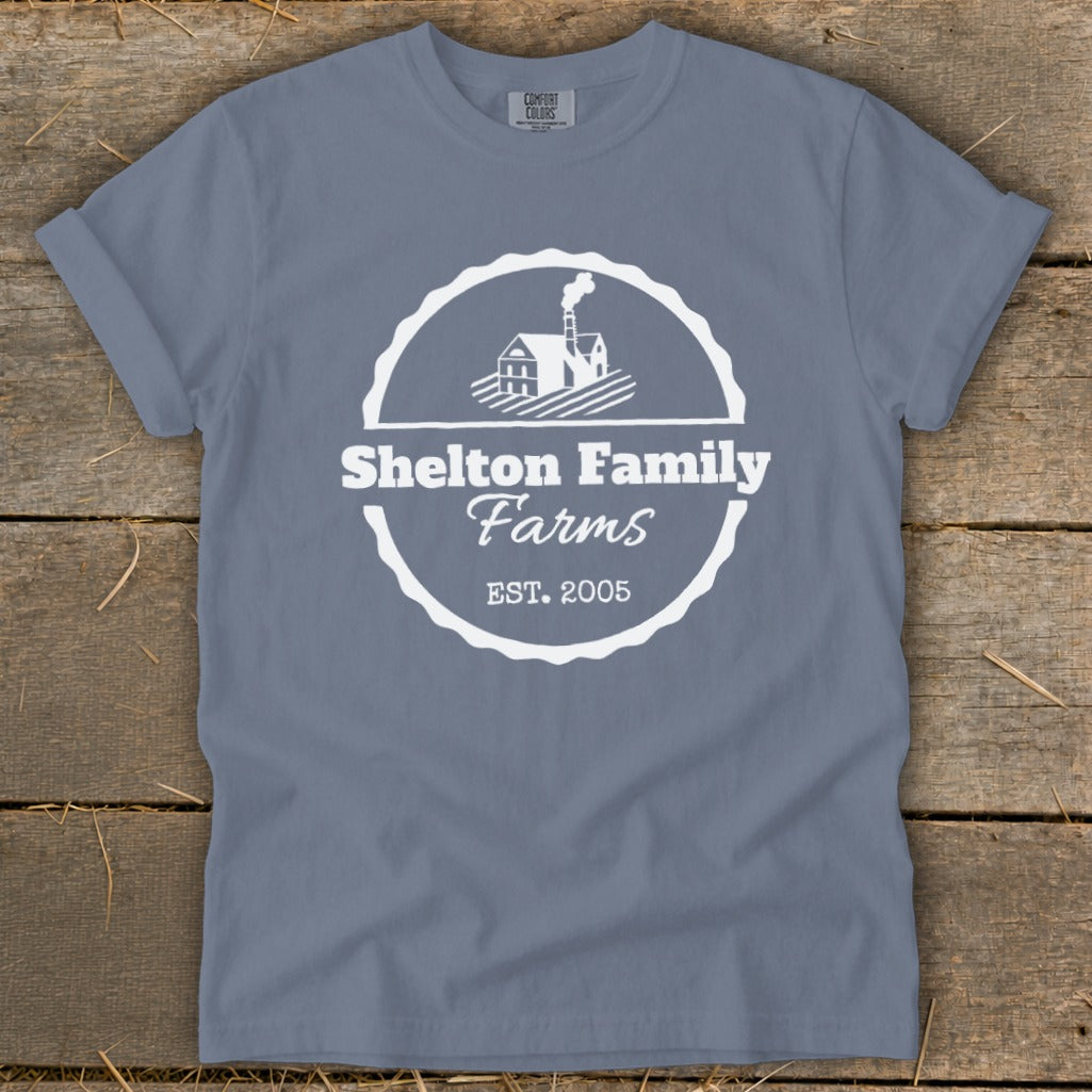 Blue t-shirt with white Shelton Family Farms logo featuring a house and EST. 2005.