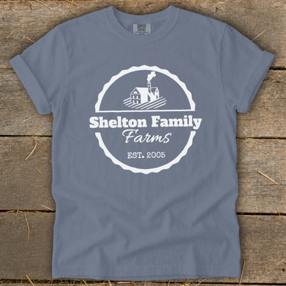 Blue t-shirt with white Shelton Family Farms logo featuring a house and EST. 2005.