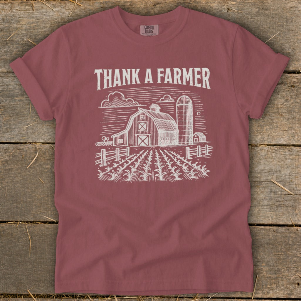 Maroon t-shirt with "Thank a Farmer" text and a farm scene illustration.