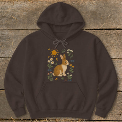 Brown hoodie with a graphic of a brown and white rabbit surrounded by flowers and a sun.