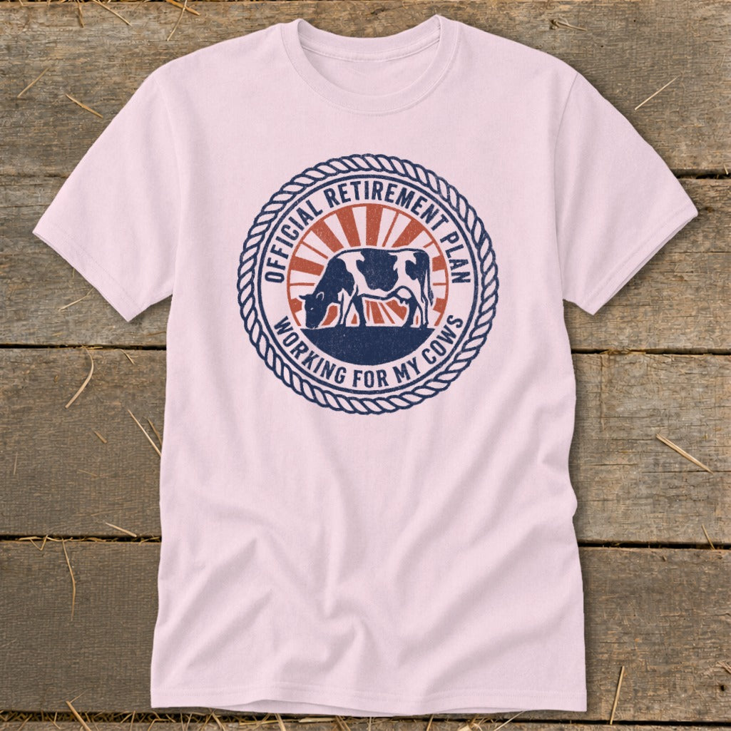 Pink t-shirt with a circular graphic of a cow and text "Official Retirement Plan Working for My Cows".