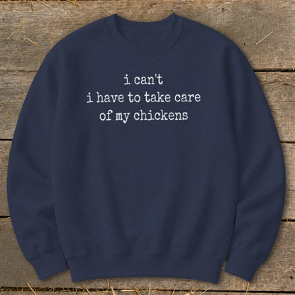 Navy sweatshirt with white text that reads "i can't i have to take care of my chickens."