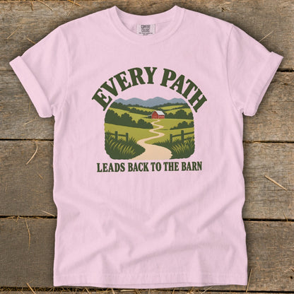 Pink t-shirt with a graphic of a barn and landscape with text "EVERY PATH LEADS BACK TO THE BARN".