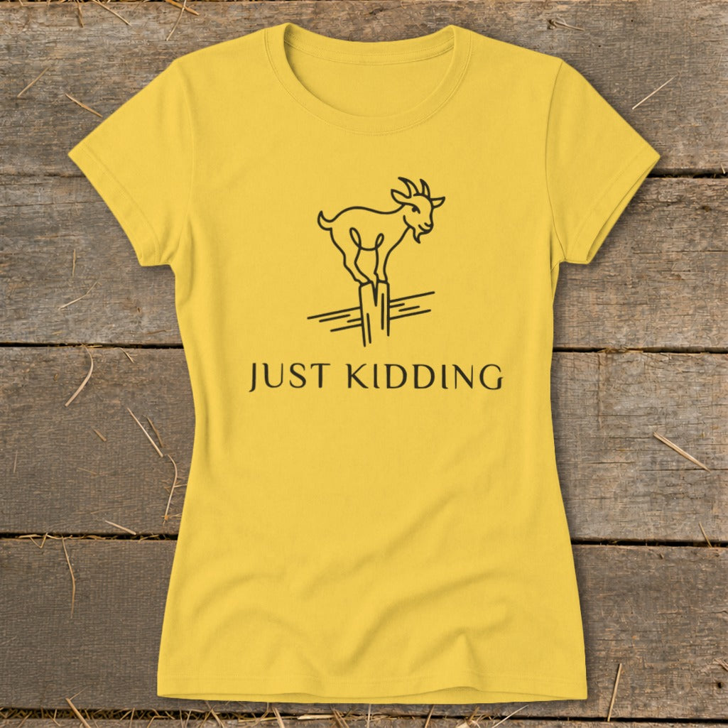 Yellow t-shirt with a black line drawing of a goat on a post and the text "JUST KIDDING".