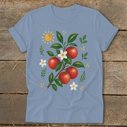 Light blue t-shirt with illustration of apples, blossoms, and sun.