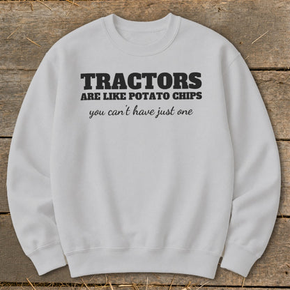 Light grey sweatshirt with black text reading "TRACTORS ARE LIKE POTATO CHIPS you can't have just one".