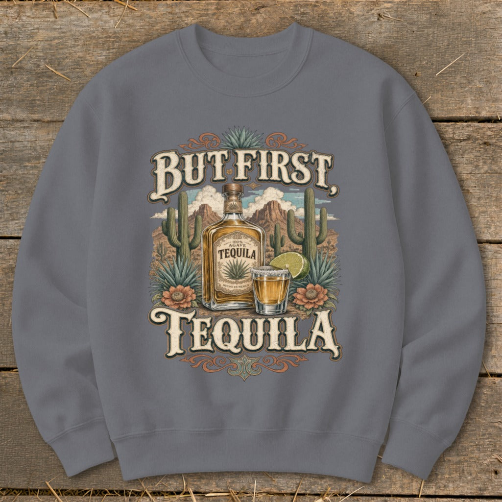 Grey sweatshirt with "But First, Tequila" graphic featuring a tequila bottle, shot, and desert landscape.