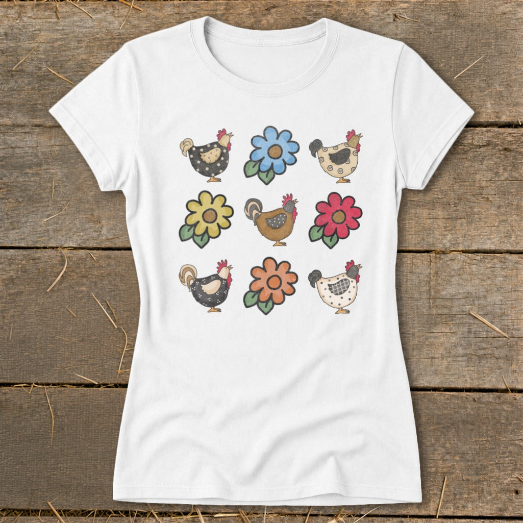 White t-shirt with a nine-panel print of farm chickens and colorful flowers.