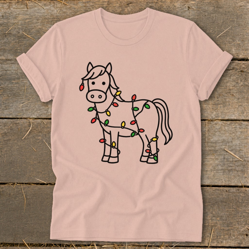 Light pink t-shirt with a line drawing of a horse decorated with colorful Christmas lights.