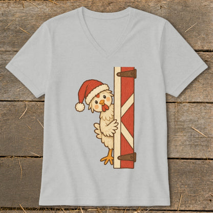 Cartoon chicken wearing Santa hat peeking from barn door.