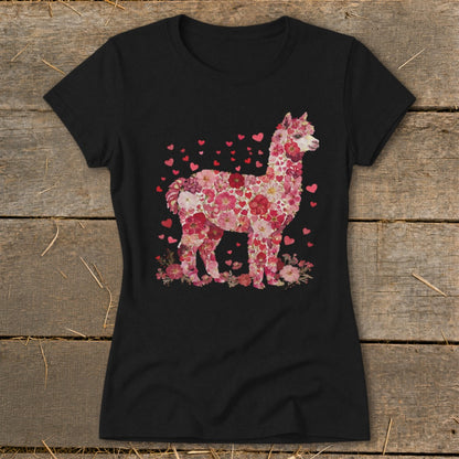Alpaca graphic made of pink flowers and hearts on a black t-shirt.