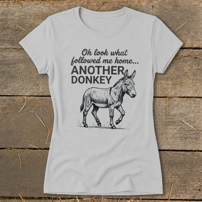 Light grey t-shirt with black text and donkey graphic that reads "Oh look what followed me home... ANOTHER DONKEY"