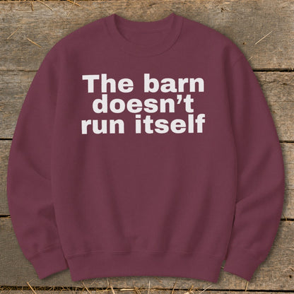 Maroon sweatshirt with white text reading "The barn doesn't run itself."