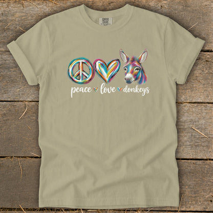 Tan t-shirt with "Peace Love Donkeys" graphic featuring a peace sign, heart, and donkey.
