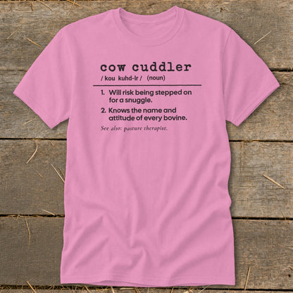 Pink t-shirt with "cow cuddler" definition: 1. Will risk being stepped on for a snuggle. 2. Knows the name and attitude of every bovine.