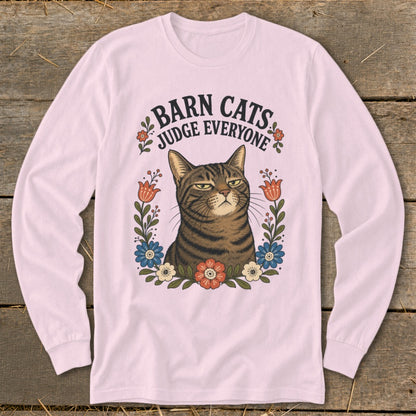 T-shirt graphic featuring a judgmental cat surrounded by flowers with text "Barn Cats Judge Everyone".