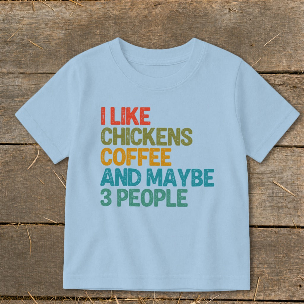 Light blue t-shirt with text "I LIKE CHICKENS COFFEE AND MAYBE 3 PEOPLE".