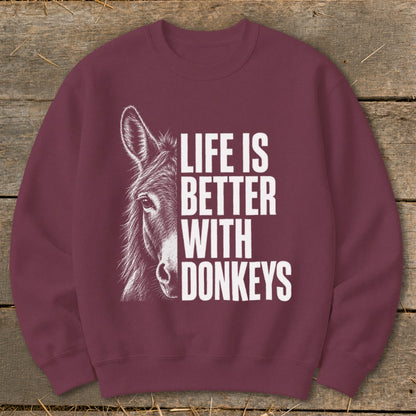 Maroon sweatshirt with a donkey illustration and text "LIFE IS BETTER WITH DONKEYS".
