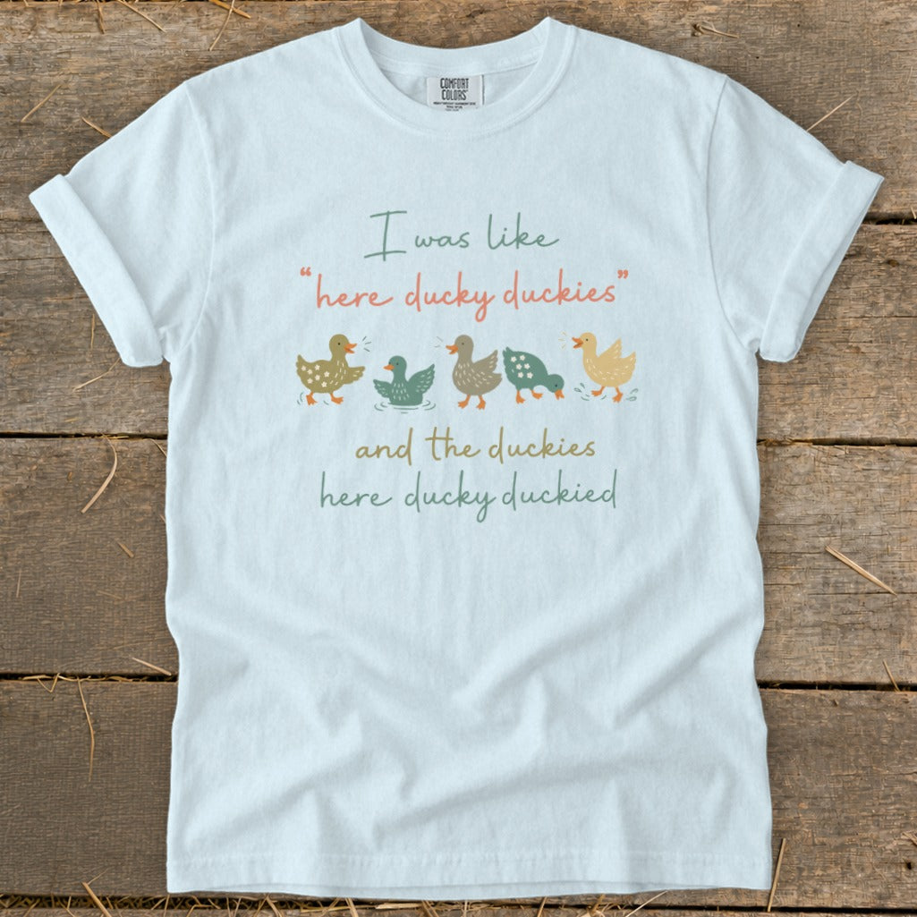 White t-shirt with "I was like 'here ducky duckies'" and five cartoon ducks.