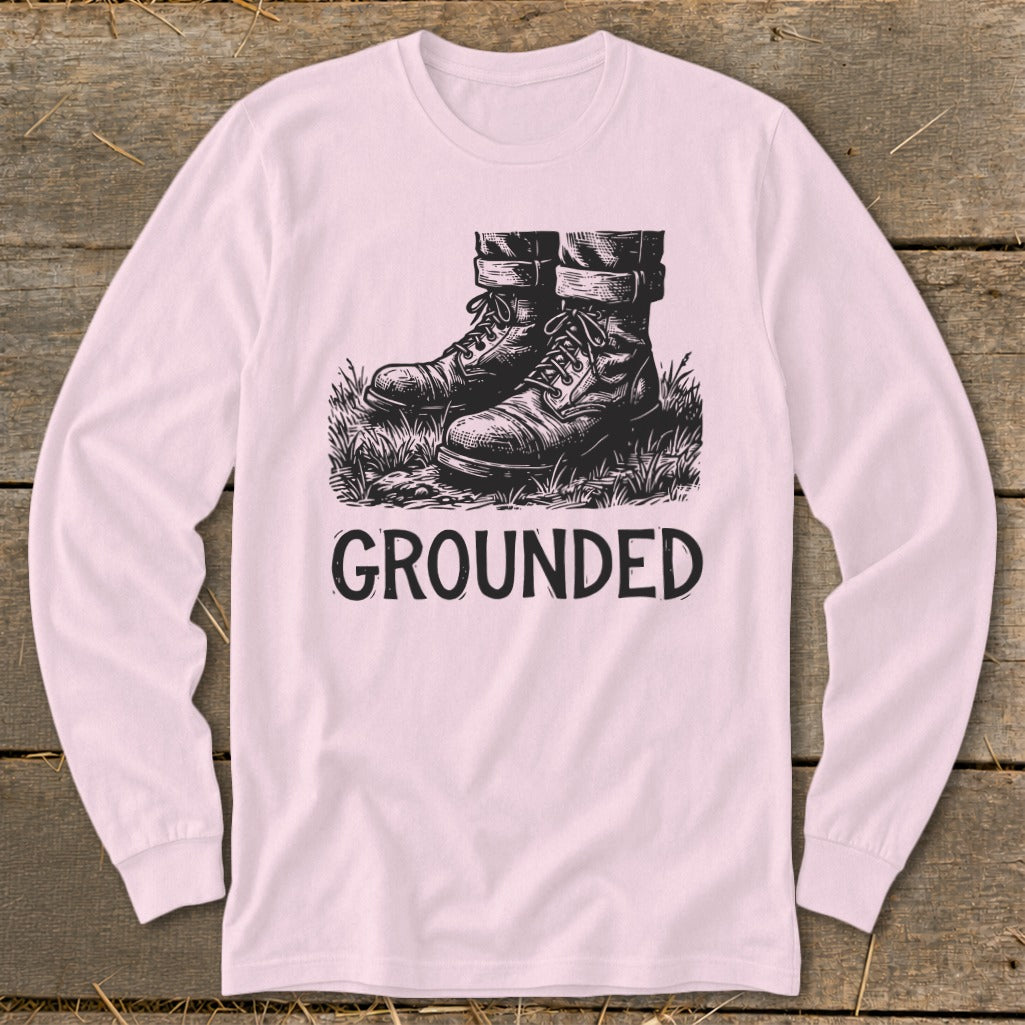Long sleeve shirt with a graphic of boots in grass and the word "GROUNDED".