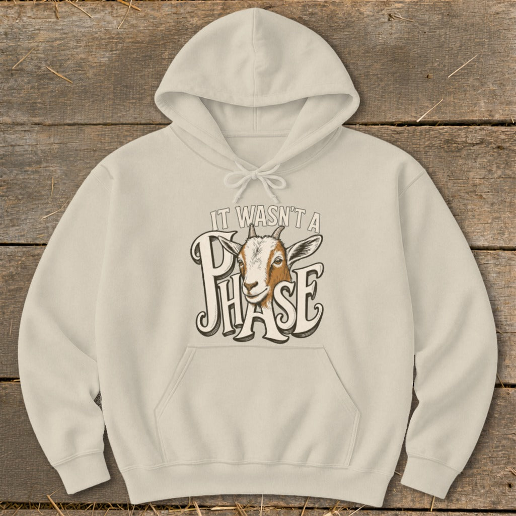 Cream hoodie with a goat graphic and text "IT WASN'T A PHASE".