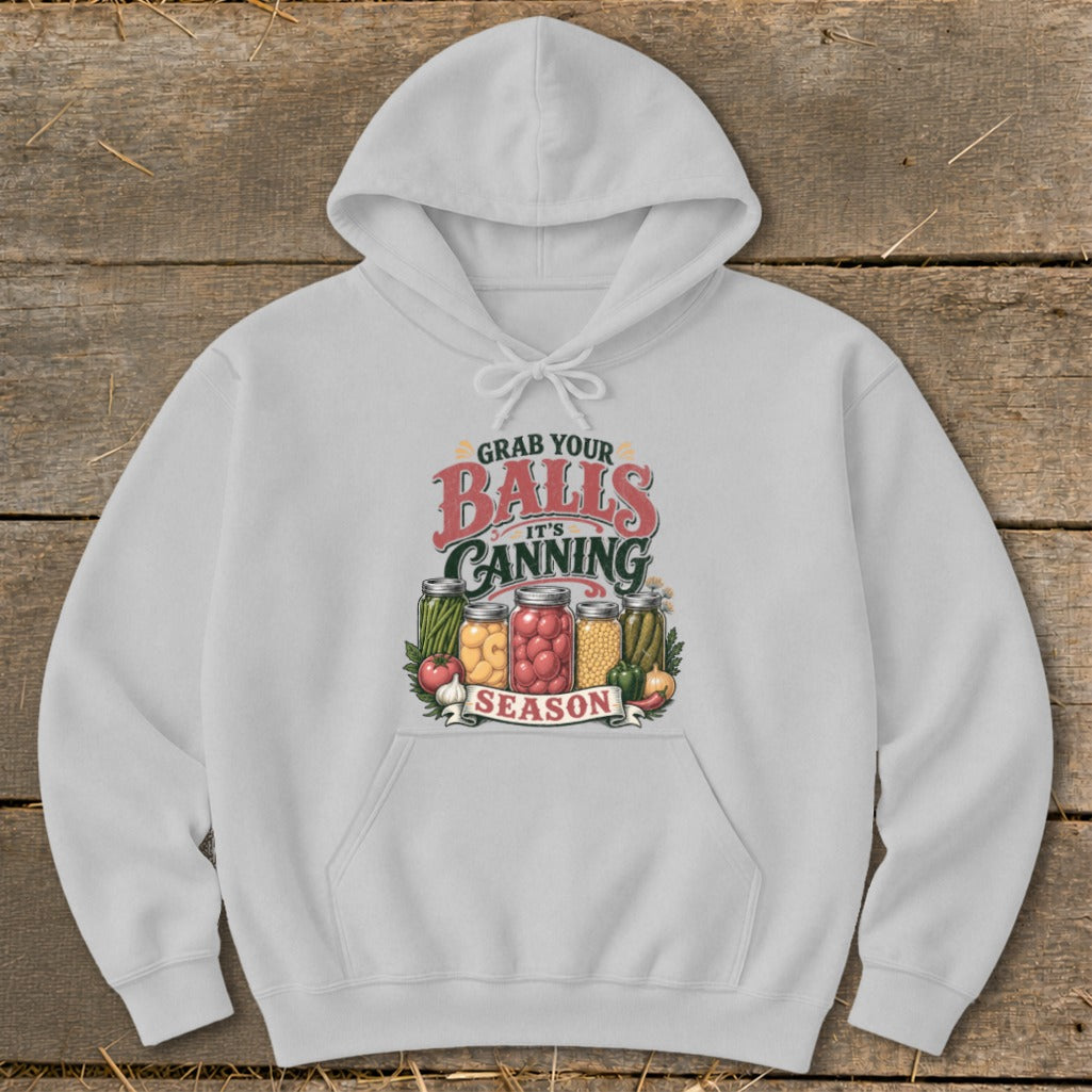 White hoodie with "Grab Your Balls It's Canning Season" graphic featuring jars of pickled vegetables.