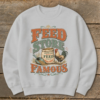White sweatshirt with "Feed Store Famous" text, a bag of feed, and a rooster.