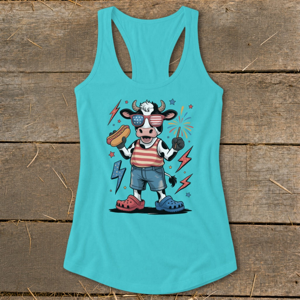 Cartoon cow in patriotic clothing holding hot dog and sparkler, with fireworks.