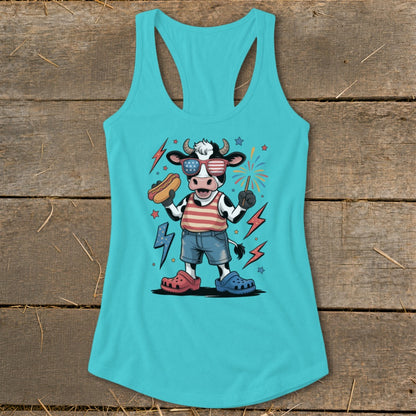 Cartoon cow in patriotic clothing holding hot dog and sparkler, with fireworks.