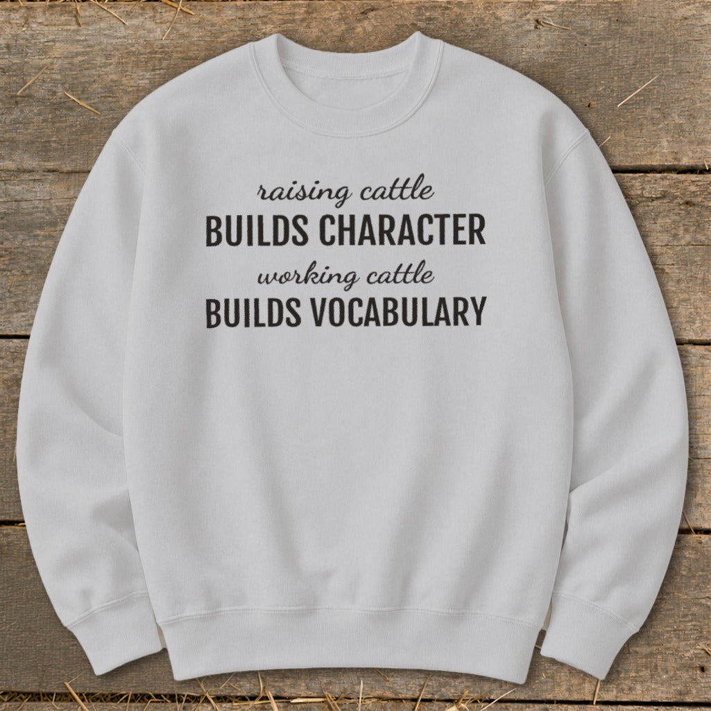 Light gray sweatshirt with "raising cattle BUILDS CHARACTER working cattle BUILDS VOCABULARY" text.