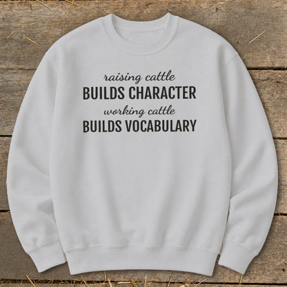 Light gray sweatshirt with "raising cattle BUILDS CHARACTER working cattle BUILDS VOCABULARY" text.