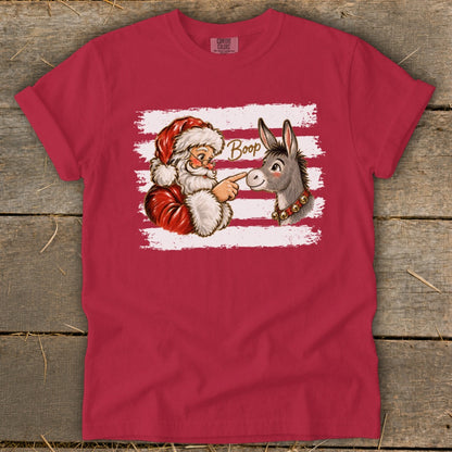 Santa booping a donkey with the word "Boop" on a red t-shirt.