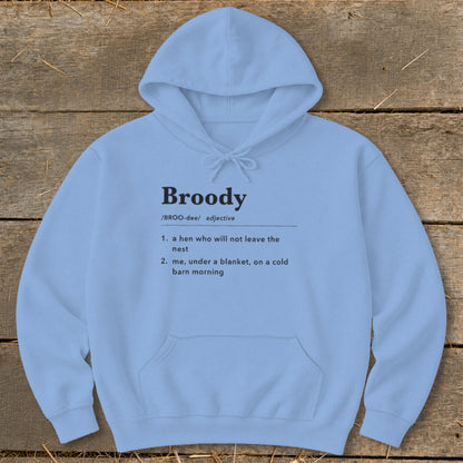 Light blue hoodie with "Broody" definition: "a hen who will not leave the nest" and "me, under a blanket, on a cold barn morning".