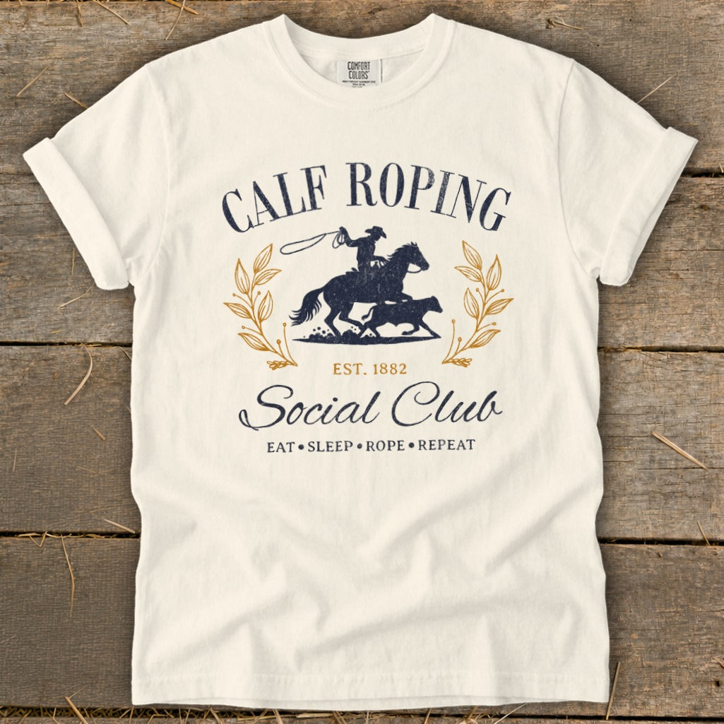 Cream t-shirt with "Calf Roping Social Club" text and rodeo graphic.