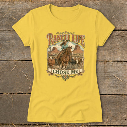 Yellow t-shirt with "Ranch Life Chose Me" graphic of a woman on a horse herding cattle.