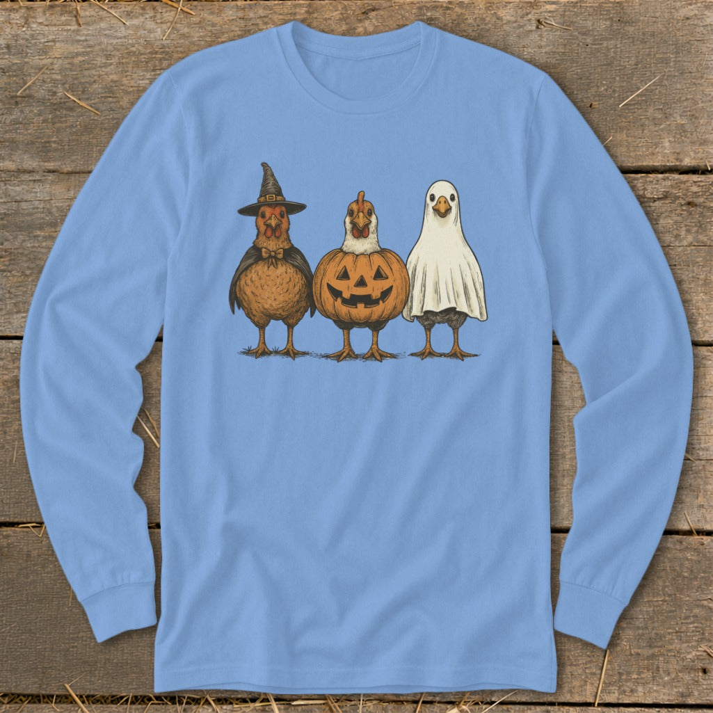 Three chickens dressed for Halloween: witch, pumpkin, and ghost.