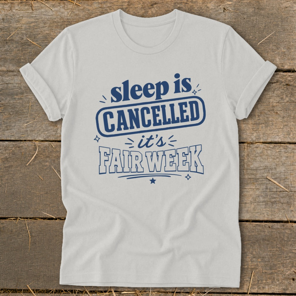 White t-shirt with blue text: "sleep is CANCELLED it's FAIR WEEK".