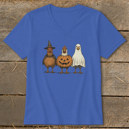 Three chickens dressed for Halloween: witch, pumpkin, and ghost.