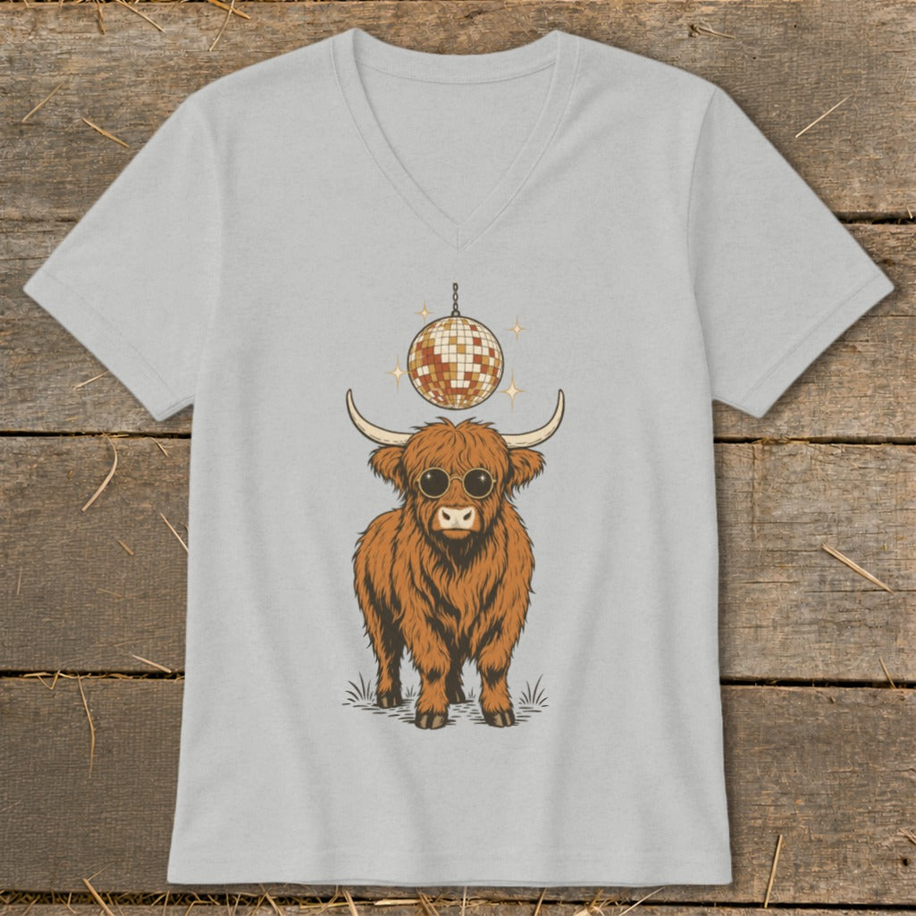 Highland cow wearing sunglasses under a disco ball on a light grey t-shirt.